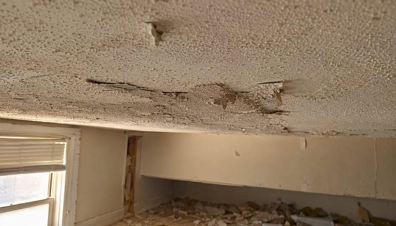 Close-up of damaged friable asbestos ceiling texture
